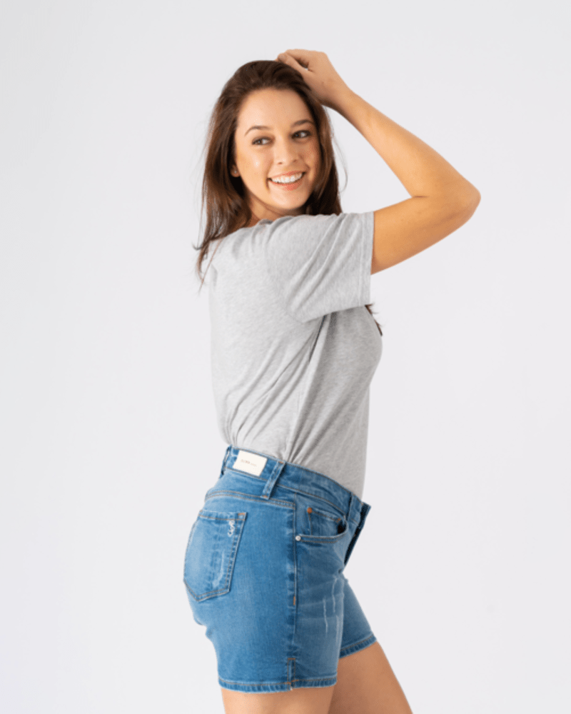 Side of a model wearing a size 10 Baylee Side Vent Shorts in GIA by Slink Jeans. | dia_product_style_image_id:255951